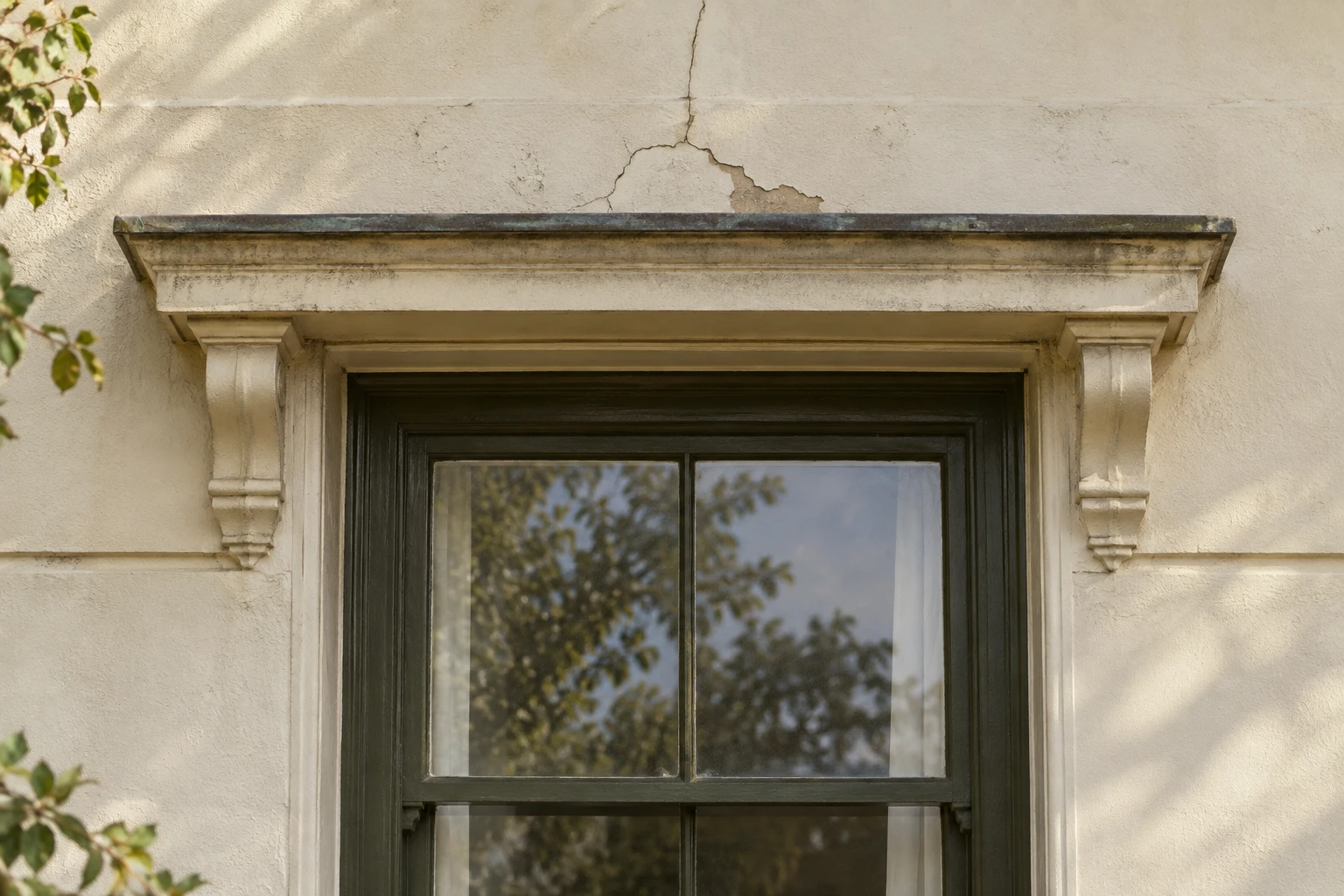 Cracking above a rendered window surround, introducing the need for a closer assessment.
